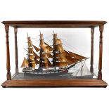 A model of a 19th century clipper, with wooden sails in full sail,