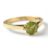 A 9ct gold ring with claw set single peridot, size K, approx 1.6g.