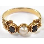 A 19th century yellow metal garnet and pearl ring, size N, approx. 2.5g.