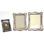 Three hallmarked silver tabletop photograph frames, one plain with beaded edging,