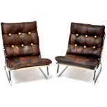 A pair of mid-20th century retro low lounge chairs with button pressed brown leather pads over a