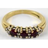 A 9ct yellow gold red topaz and diamond half eternity ring, size H, approx 2.3g.