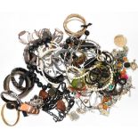 A quantity of various costume jewellery to include brooches, bangles, bracelets, necklaces,