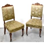 A set of four 19th century oak dining chairs, carved top rail to overstuffed seat,