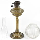 An Edwardian brass oil lamp with scroll decorated oil reserve,