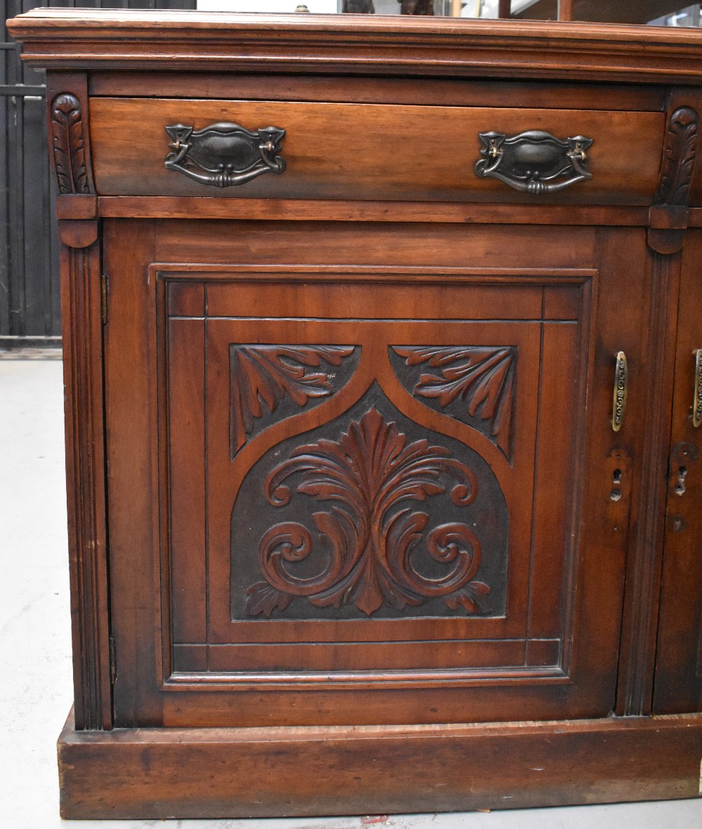 A Victorian mahogany sideboard, two curved drawers over two carved panel doors, to plinth base, - Bild 2 aus 3