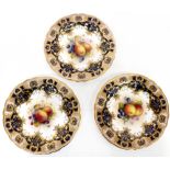 ROYAL WORCESTER; a matched set of three porcelain cabinet display plates decorated by Albert Shuck,