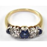 An 18ct gold diamond and blue stone ring, the claw set diamonds each approx. 0.