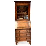 An early 20th century oak Arts & Crafts style bureau of small proportions,