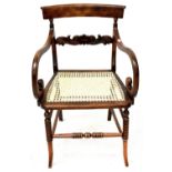 A late 19th/early 20th century walnut and bergère armchair.