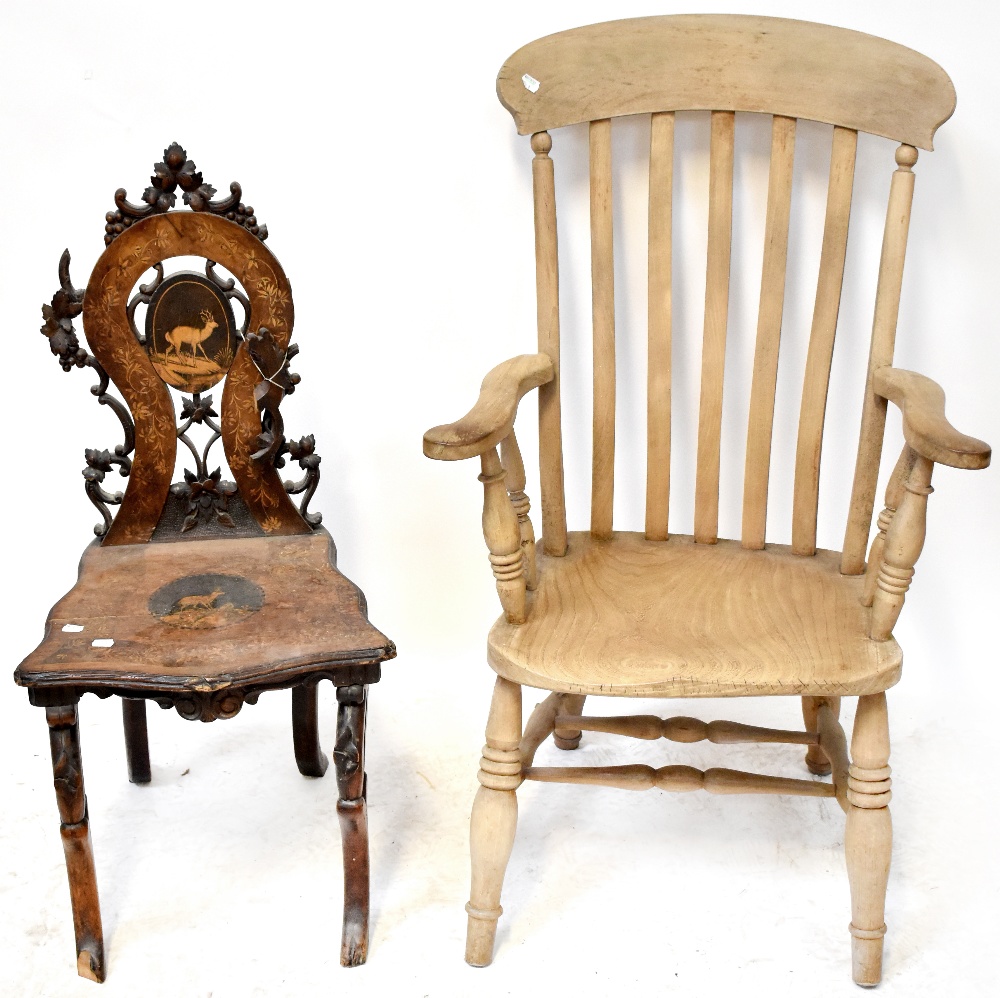 A Victorian hall chair with carved vine and grape decoration to the top and sides,