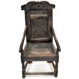 A 17th century carved oak wainscot armchair,