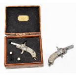 A pair of cased miniature pin-fire pistols, both with bright cut detail to grips, length of each 4.