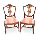 A set of six Hepplewhite style mahogany dining chairs, with shield shaped backs and drop in seats,