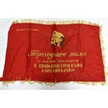 A Russian Soviet propaganda flag decorated with the busts of Lenin and Stalin and with writing in