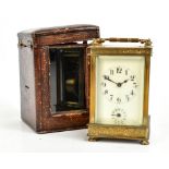 A late 19th century French brass carriage clock, the circular dial set with Arabic numerals and