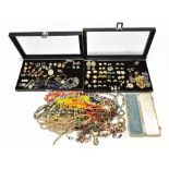 A collection of costume jewellery including pairs of earrings, necklaces, brooches, etc, in two