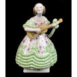 HEREND; a figure representing a girl wearing a green floral dress playing the guitar, factory mark