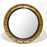 A Regency style gilt framed circular convex wall mirror, diameter 57cm.
