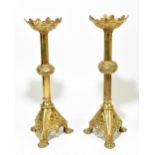 A near pair of 19th century ecclesiastical brass Gothic Revival candlesticks, with knopped stems
