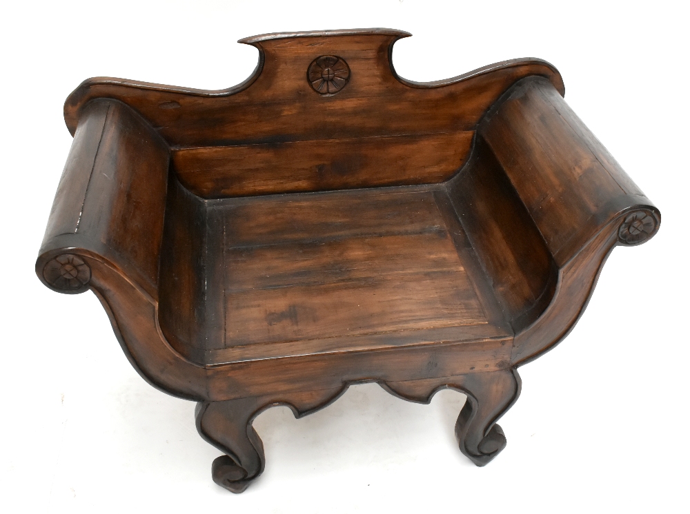 A reproduction stained child's chair with carved floral detail to the back panel and arms, height