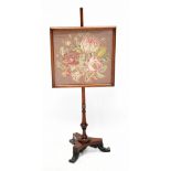 A late 19th century mahogany pole screen, with applied tapestry panel, raised on three swept feet,