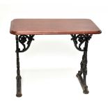 A Victorian cast iron framed pub table, with glazed mahogany top, raised on scrolling feet, width