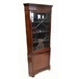 A 19th century mahogany freestanding corner cupboard, the upper section with single astragal