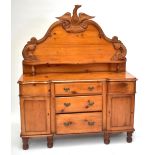 A carved pine sideboard, the single shelf on raised back with eagle crest, on base with five short