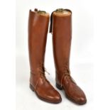 A pair of tan leather field boots, with sectional boot trees with label for Maxwell of London,