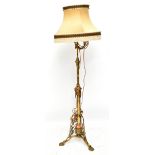 A Victorian lacquered brass and copper standard lamp, on triform base with brass paw feet, height