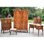 WARING & GILLOWS; a three-piece walnut bedroom suite comprising crossbanded dressing chest with