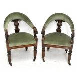 A pair of William IV carved rosewood library tub chairs, with upholstered backs and seats and scroll