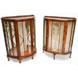 Two similar 1930s walnut veneered bow front display cabinets on cabriole legs, the taller 115 x 89 x