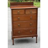 A 1920s mahogany chest with two short and three long drawers, on turned legs, height 115cm, width