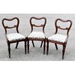 Three Victorian carved mahogany buckle back dining chairs, on carved and turned tapered legs, height