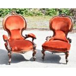 A pair of Victorian carved walnut gentleman's and lady's spoon back armchairs, upholstered in a deep