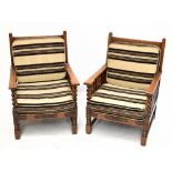 A pair of early 20th century carved oak splat back armchairs, with carved detail to the front and