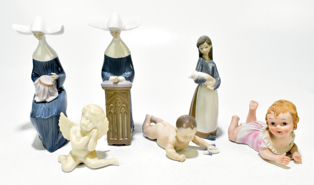 LLADRO; three figures comprising seated 'Nun Sewing', number 5501, 'Nun Praying', number 5502, and a