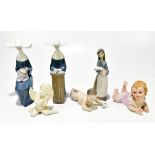 LLADRO; three figures comprising seated 'Nun Sewing', number 5501, 'Nun Praying', number 5502, and a