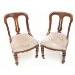 A set of four Victorian carved walnut arch back dining chairs, upholstered in a grey checkered