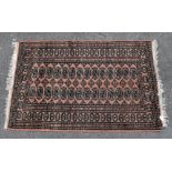 An Eastern style rug with elephant foot decoration inside a checkered border, approx 155 x 100cm.