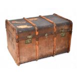 An early/mid-20th century metal bound travelling trunk with arched top and wooden slats, with