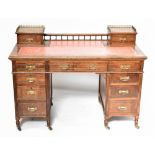 A Victorian oak knee hole desk, with galleried back and two small drawers, with leather inset to the