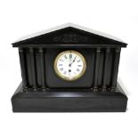 A Victorian slate mantel clock of architectural form, the central enamel dial with Roman numerals,