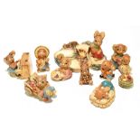 A collection of eleven Pendelfin rabbit figures and ornaments, together with a four section stage (