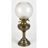 A 20th century brass oil lamp with frosted glass shade, raised on a single Corinthian column, height