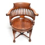 An early 20th century walnut revolving desk chair on stretchered cabriole supports. Additional
