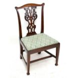 A carved mahogany dining chair with carved and pierced splat above a drop-in seat on tapered legs.