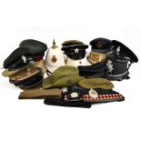 A collection of military hats and helmets, including beret with gilt bullion badge for the Queen's